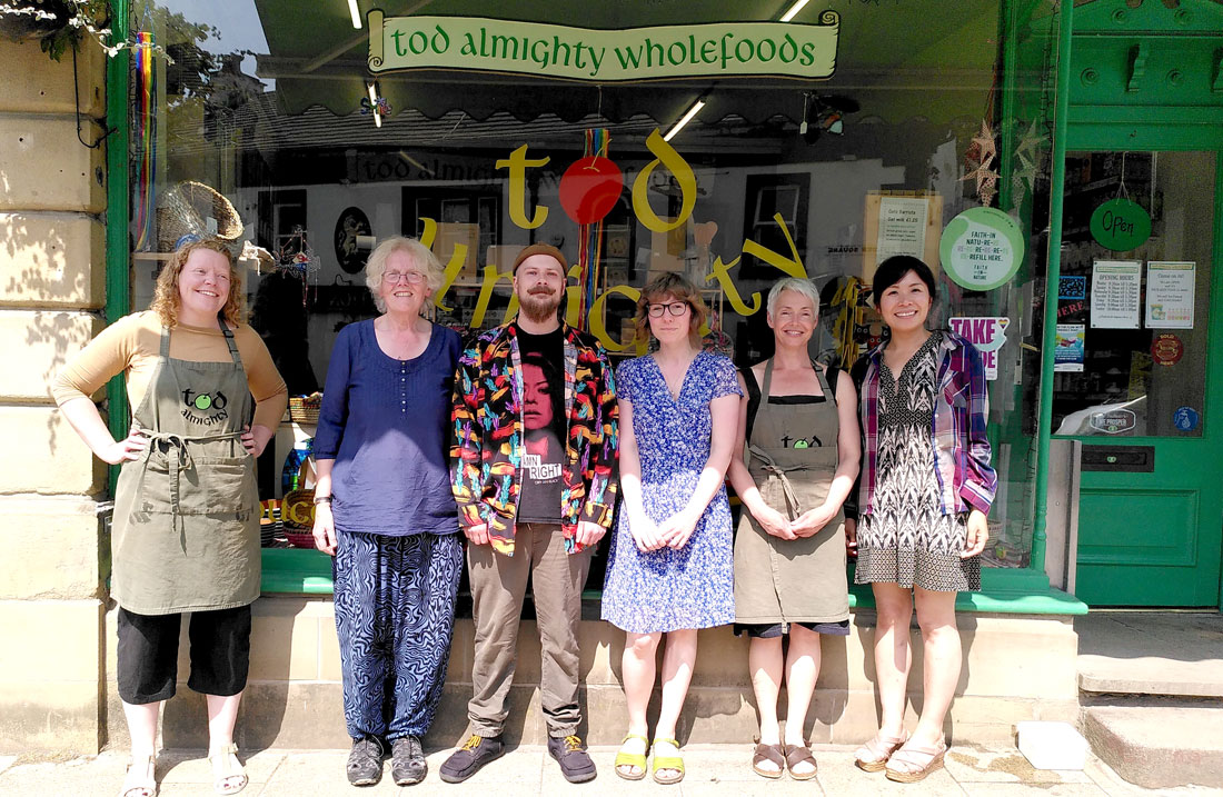 Photo of Tod Almighty Wholefoods staff taken on the hottest day of the year - 19 July 2022 - outside the shop